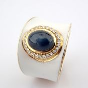 A luxurious gold ring featuring white laser enamel, adorned with vibrant ''cab'' cut Sapphire
