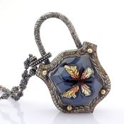 Clasp necklace with gold, topaz, reversely engraved intaglio butterfly, and diamonds on silver
