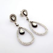 18K white gold earring with fancy cut diamond on silver frame and brilliant diamonds and gold