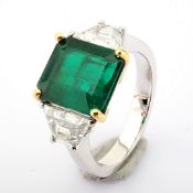 A luxurious 18k white gold ring detailed with vibrant 3.29 ct emerald and 1.16 ct brilliant diamond.