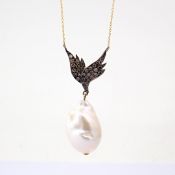 An exquisite wing necklace detailed with baroque pearl , brilliant diamonds and gold on silver.