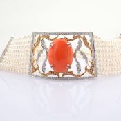 An exquisite pearl chocker detailed with coral and brilliant diamonds
