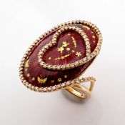 An exquisite 18K yellow gold ring with red enamel, grains of gold dust and brilliant diamonds