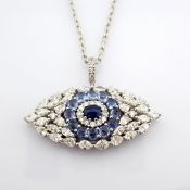 14K large evil eye necklace detailed with vibrant sapphire and brilliant diamonds