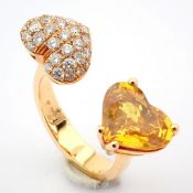 An exquisite heart ring detailed with vibrant yellow heart cut sapphire and brilliant diamonds