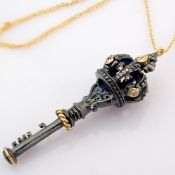 An exquisite crown key necklace detailed with brilliant diamonds and gold on silver