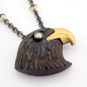 Ebony-carved eagle head necklace , detailed with brilliant diamonds and 18K gold on silver