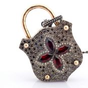 An exquisite clasp necklace embellished with gold, colourful stones and diamonds on silver