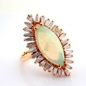 An exquisite 18k rose gold ring detailed with opal and brilliant diamonds.