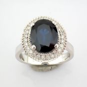 An exquisite 18k white gold cluster ring detailed with sapphire and brilliant diamonds