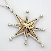 14 white and yellow gold star necklace detailed with brilliant diamonds