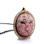 Hand-made necklace detailed with topaz with reversely engraved intaglio tiger and brilliant diamond.