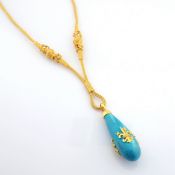 A handwoven 24kt gold necklace adorned with precious stones.