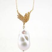 An exquisite wing necklace detailed with baroque pearl .brilliant diamonds and gold