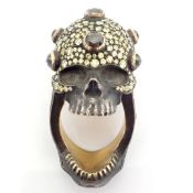 An exquisite hand-made skull ring detailed with brilliant diamonds and gold on silver.