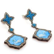 An exquisite earrings made of brilliant diamonds and gold in silver detailed of micro art