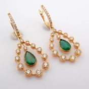 18K rose gold earrings detailed with vibrant emerald and brilliant diamonds