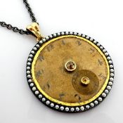 An exquisite necklace made of gold and silver, featuring an antique watch dial with diamonds