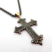 An exquisite cross necklace detailed with brilliant diamonds and gold on silver.