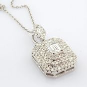 An exquisite 18k white gold necklace detailed with baguette and brilliant diamonds