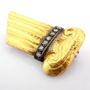 A mythological object brooch engraved in 24-carat gold with silver accents and diamonds