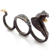An exquisite snake ring detailed with brilliant diamonds and gold on silver.