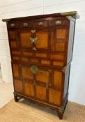 A Korean two toned cabinet comprising of two cupboards with four drawers over, brass hinges, handles