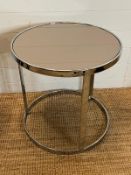 An Italian contemporary circular smoked glass coffee table on chrome frame by Minotti (H56cm Dia