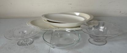 A collection of white ceramic plates and glass dishes