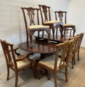 An Edwardian style mahogany extending dining table on claw and ball feet and eight chairs to include