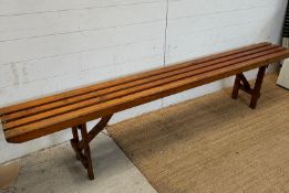A vintage pine collapsible slatted bench (H45cm W213cm)