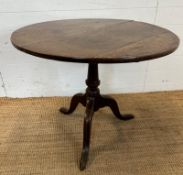 A circular oak pedestal table. Turned central support on splayed tripod legs. Diameter 83 height 70