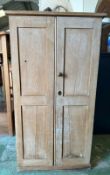 A vintage pine two door cupboard opening to eleven shelved compartments (H125cm W66cm D49cm)