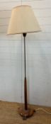 A Mid Century teak and brass standard lamp