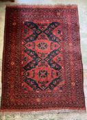 A reg ground rug with blue cross style details 160cm x 103cm