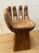 A wooden carved seat or stool in the form of a hand (H62cm)