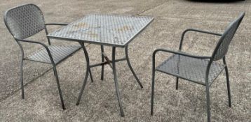 A metal starburst garden table and two chairs (H73cm SQ70cm)