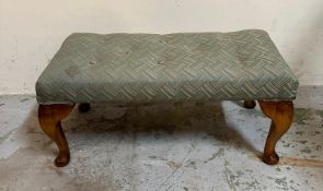A button tufted green upholstered foot stool