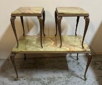 A marble onyx topped coffee table on brass rococo style legs and two matching side tables (H44cm
