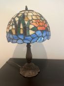 Tiffany style lamp with scenes of water and flowers on glass shade