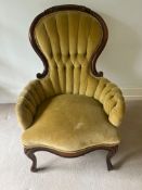 A salon chair with button back and scrolling mahogany frame