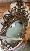 A large George lll gilt wood oval mirror. The frame with urn cresting and floral and foliate scrolls