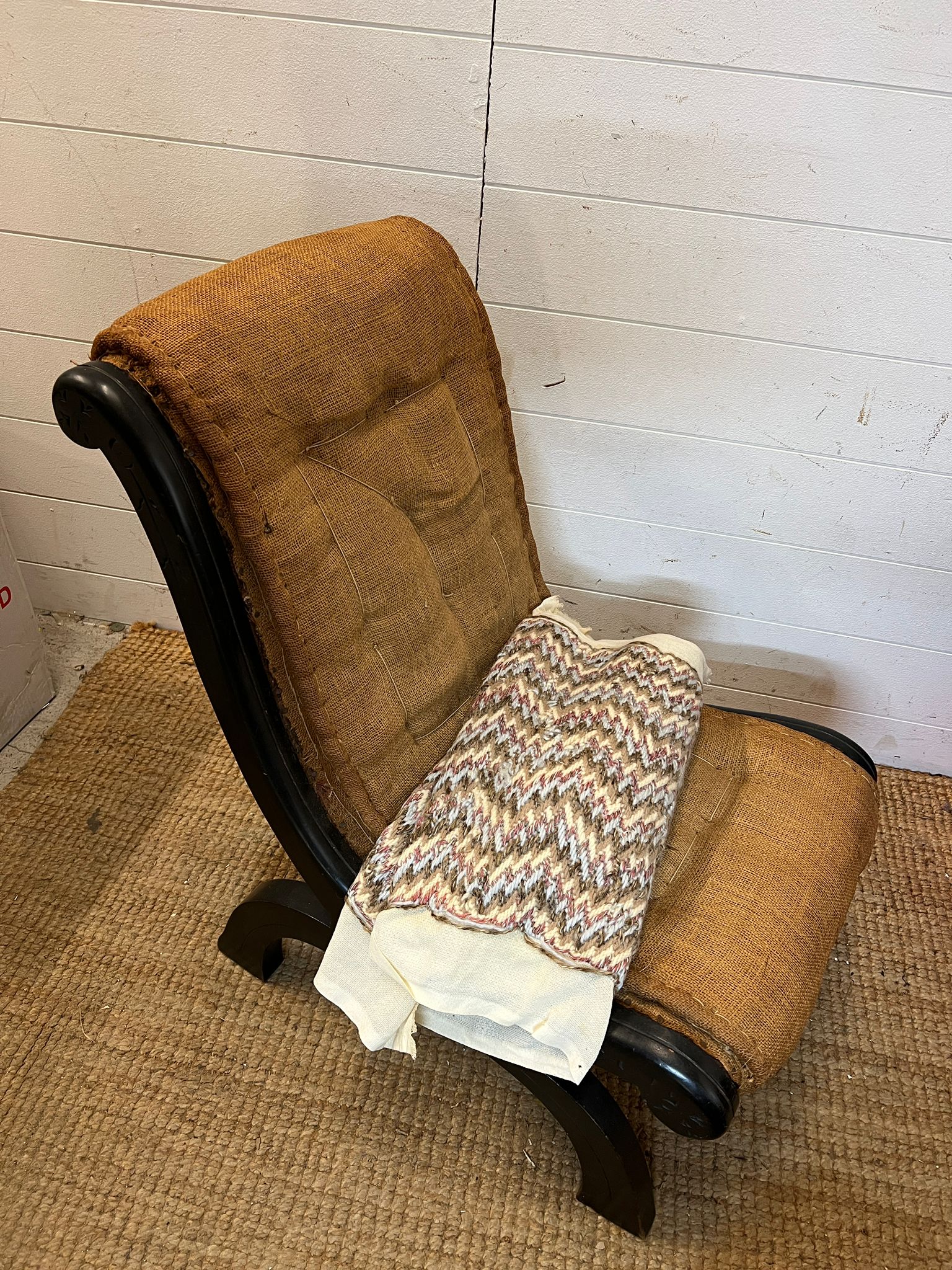 A slipper chair or nursing chair in need of recovering