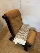 A slipper chair or nursing chair in need of recovering