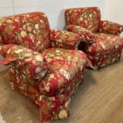 A pair of swivel arm chairs upholstered in a red ground fruit tree fabric