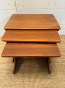 A nest of three Mid Century teak side tables (H41cm W60cm D39cm)