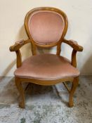 A spoon back open arm chair upholstered in pink