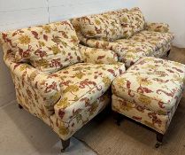 A three seater sofa with matching arm chair and footstool by Edward Ferrell upholstered in a
