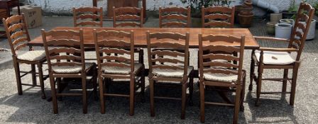 A large oak dining table with ten ladder back chairs (H73cm W243cm D90cm)