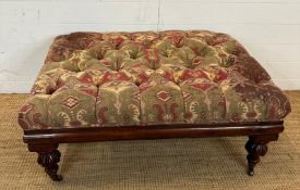 A mahogany framed ottoman or foot stool button tufted and upholstered in red and greens (H46cm